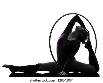 one caucasian woman exercising Rhythmic Gymnastics hula hoop  in silhouette studio isolated on white background - Powered by Shutterstock