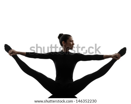 one caucasian woman practicing gymnastic yoga stretching split  in silhouette   on white background