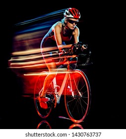 One Caucasian Woman Triathlon Triathlete Cyclist Cycling Studio Shot Isolated On Black Background With Light Painting Effect