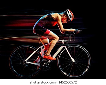 One Caucasian Woman Triathlon Triathlete Cyclist Cycling Studio Shot Isolated On Black Background With Light Painting Effect