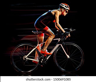 One Caucasian Woman Triathlon Triathlete Cyclist Cycling Studio Shot Isolated On Black Background With Light Painting Effect