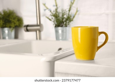 One ceramic mug on light countertop in kitchen, space for text - Powered by Shutterstock