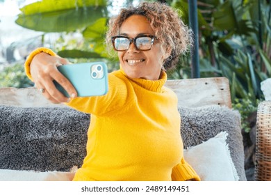 One cheerful woman taking selfie picture outside home using phone to share on social media. Video call concept communication people. Modern lady communicate with smartphone app outdoor. Leisure - Powered by Shutterstock