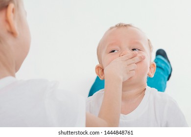 One Child Gagged The Other. The Girl Put Her Hand To The Boy's Face