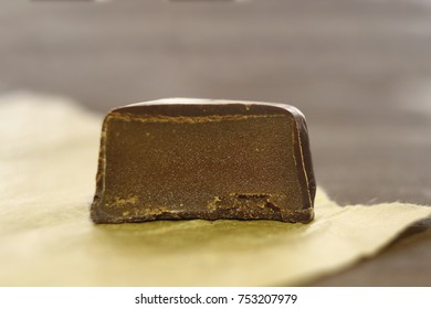 One chocolate candy cut in half on confectionery paper - Powered by Shutterstock