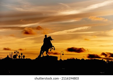 One of the city symbols - The Bronze Horseman, depicting Peter the Great. Black silhouette in sunset sky with clouds