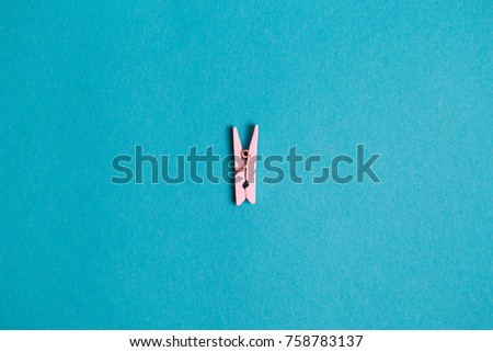 One colored clothespins on a blue background