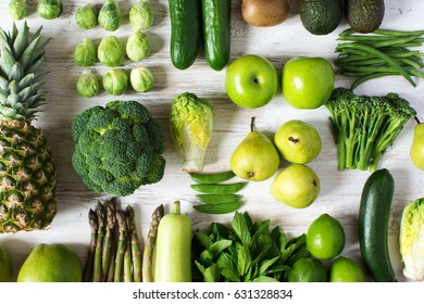 One colour, healthy eating concept, green fruits and vegetables arranged in grid, apples, pears, broccoli, peas, cauliflower, beans, asparagus, kiwi, avocado, pineapple on white table, selective focus - Powered by Shutterstock