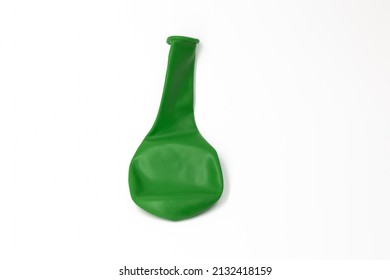 One dark green inflatable uninflated colored balloon for the holiday lies on a white background isolated