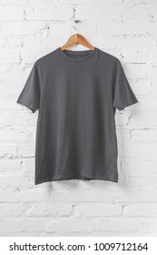 One Dark Grey Shirt On Hanger On White Wall