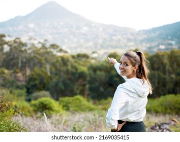 One Day Im Going To Conquer That Mountain. Portrait Of A Young Woman Pointing To A Scenic View While Exercising Outdoors.