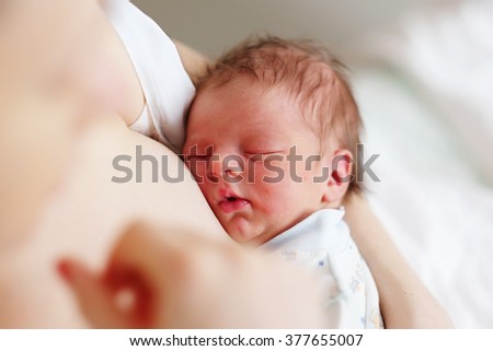 One day old newborn baby with his mother