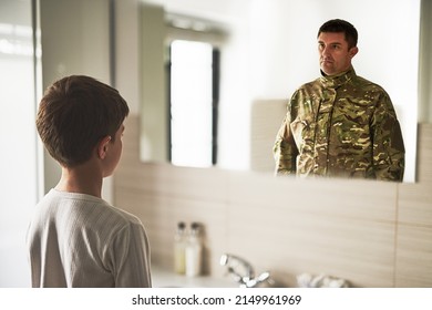 One day when I grow up. Rearview shot of a young boy seeing a soldier reflected in the mirror. - Powered by Shutterstock