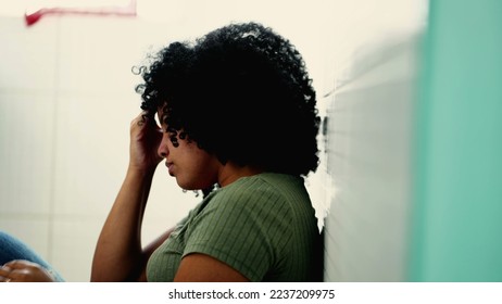 One desperate young black woman suffering from mental problems on kitchen floor. Dramatic African American adult person suffers from depression illness - Shutterstock ID 2237209975
