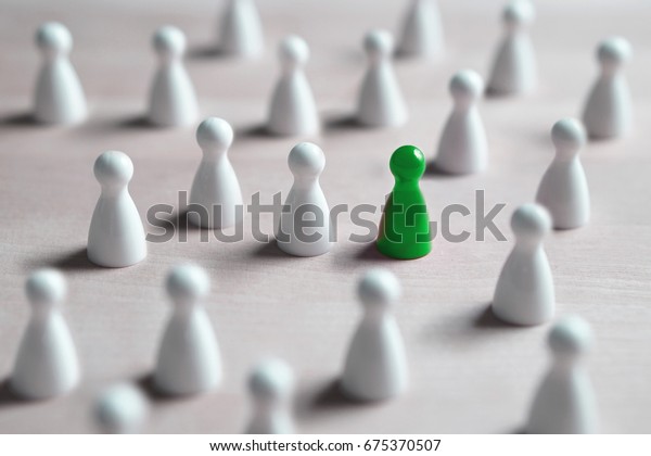 One different board game pawn.\
Individuality, independence, leadership and uniqueness concept.\
Stand out from the crowd. Think outside the box. Dare to be\
different.