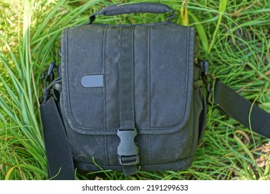 One Dirty Black Closed Bag A Wardrobe Trunk Made Of Fabric Lies On The Green Grass In Nature