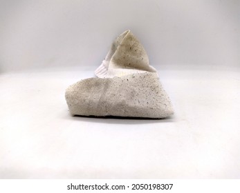 one dirty sock on white background. closeup photo