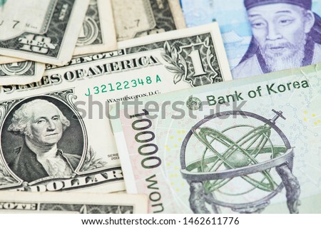 One Dollar Bill and South Korea Won Banknotes close up image. One Dollar USA USD South Korea Won KRW Money