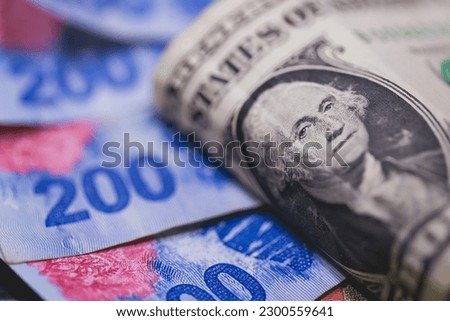 A one dollar bill from the United States with notes of money from Argentina.
