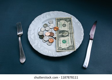 One Dollar Lying On The Plate With Fork And Knife. No Money Photo. Poor People Idea. Dimes And Cents Coins. Small Salary And Pension Not Enough For Food. Social Problems.