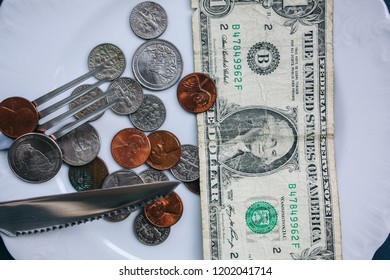 One Dollar Lying On The Plate With Fork And Knife. No Money Photo. Poor People Idea. Dimes And Cents Coins. Small Salary And Pension Not Enough For Food. Social Problems.