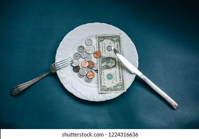 One Dollar Lying On The Plate With Fork And Knife. No Money Photo. Poor People Idea. Dimes And Cents Coins. Small Salary And Pension Not Enough For Food. Social Problems.