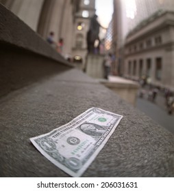 One dollar note lying alone on the steps of the Federal Hall.