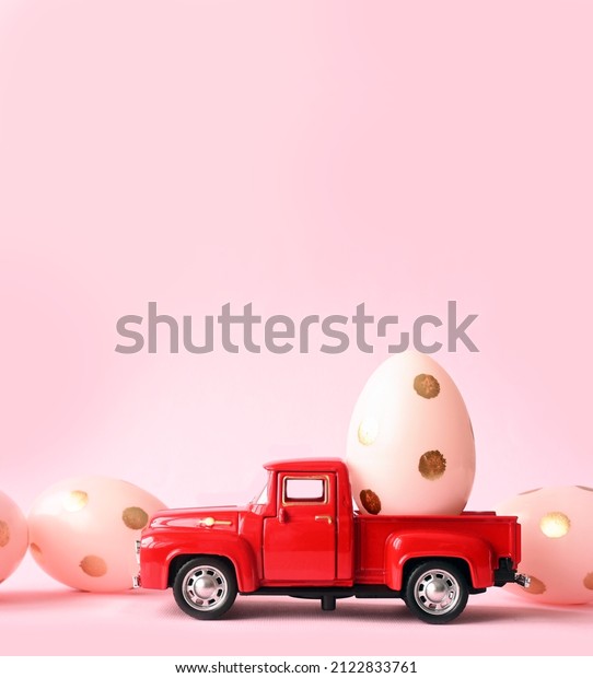 One Easter egg on a small car on a pink background.\
Copy space. Easter card.