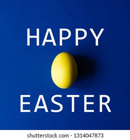 One Easter Egg Of Yellow Color On A Blue Background. Minimalism. Photos In The Square Format Is Perfect For Post To Instagram.