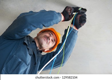 One electrician working with cable mounting and assembling new wiring