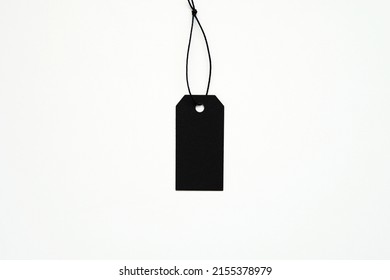 One Empty Black Price Label Tag On String, Blank Hangtag Mockup, Black Friday Sale Concept, White Background.