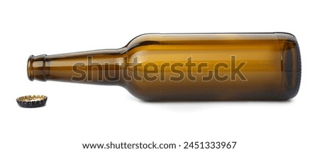 One empty brown beer bottle and cap isolated on white