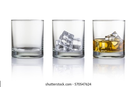 One empty glass, one full with ice cubes and glass with whiskey and ice cubes. Isolated on white background