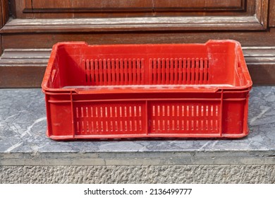 One Empty Red Plastic Crate For Produce Delivery