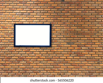 one empty wide frame on brick wall