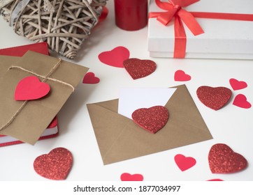one envelope with many red heart on background box gift and candle. love Valentine day on 14th February. Send love latter, small gift, confession of love to beloved. craft envelope