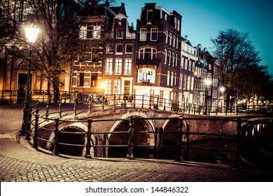 One of the famous canals of Amsterdam, the Netherlands at dusk. - Powered by Shutterstock