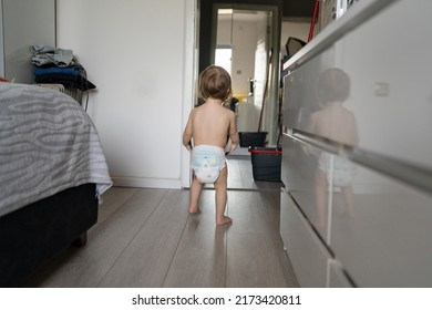 One Female Toddler Caucasian In Diapers Running In The House Early Child Development Learning And Playing Concept