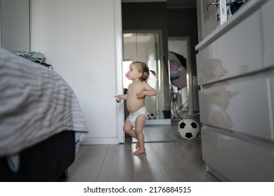 One Female Toddler Caucasian In Diapers Running In The House With Soccer Ball Early Child Development Learning And Playing Concept