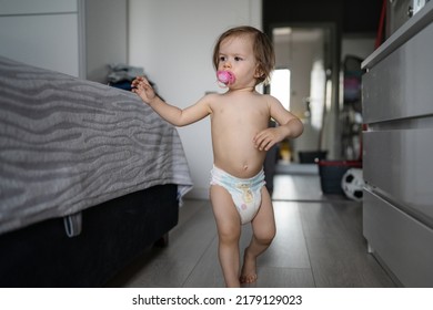 One Female Toddler Caucasian In Diapers Running In The House Early Child Development Learning And Playing Concept