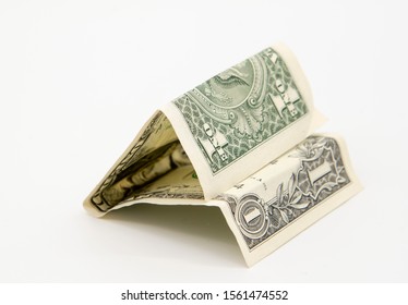 One folded dollar on a light gray background. - Shutterstock ID 1561474552