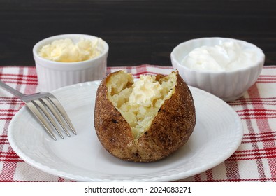 One Fresh Baked Russet Potato With A Dab Of Butter.  Close Up, Macro View.