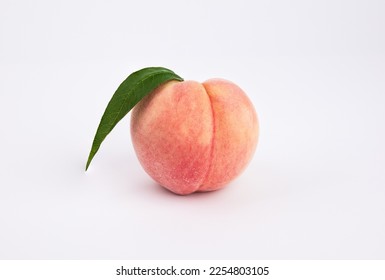 One fresh peach on a white background. Close-up from the front. - Shutterstock ID 2254803105