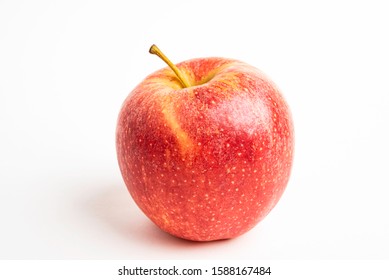 One fresh red apple isolated on a plain white background.