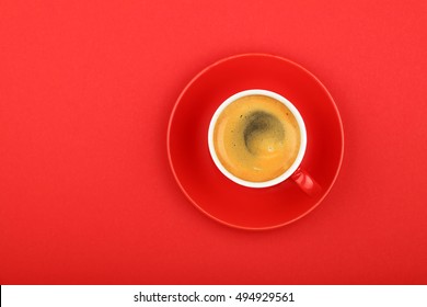 One Full Morning Espresso Coffee Shot With Crema In Small Red Cup With Saucer On Red Paper Background, Top View, Bird Eye View