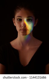 One Girl Portrait, Face Head, Prism Dispersion Of Light Into Colorful Rainbow Effect. Black Background.