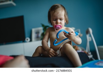 One Girl Toddler Caucasian Sitting With Parent And Playing Doctor With Medical Set Toy Early Development And Role Play Concept