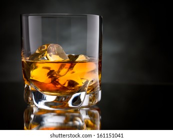 One Glass Of Whisky On The Rocks On Black Background