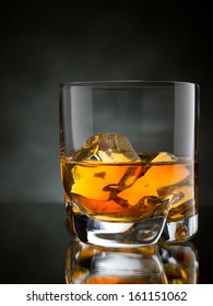 One Glass Of Whisky On The Rocks On Black Background