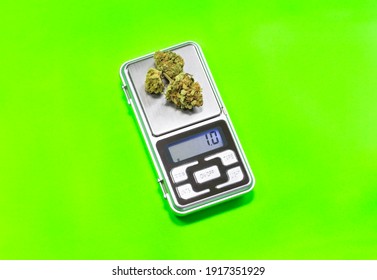 One Gram Of Cannabis Buds On Digital Scale Isolate On Green Background. Weighing Marijuana With Digital Weight.